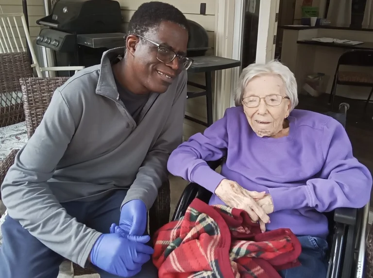 Caregiver providing support and companionship to a senior resident at a senior care community