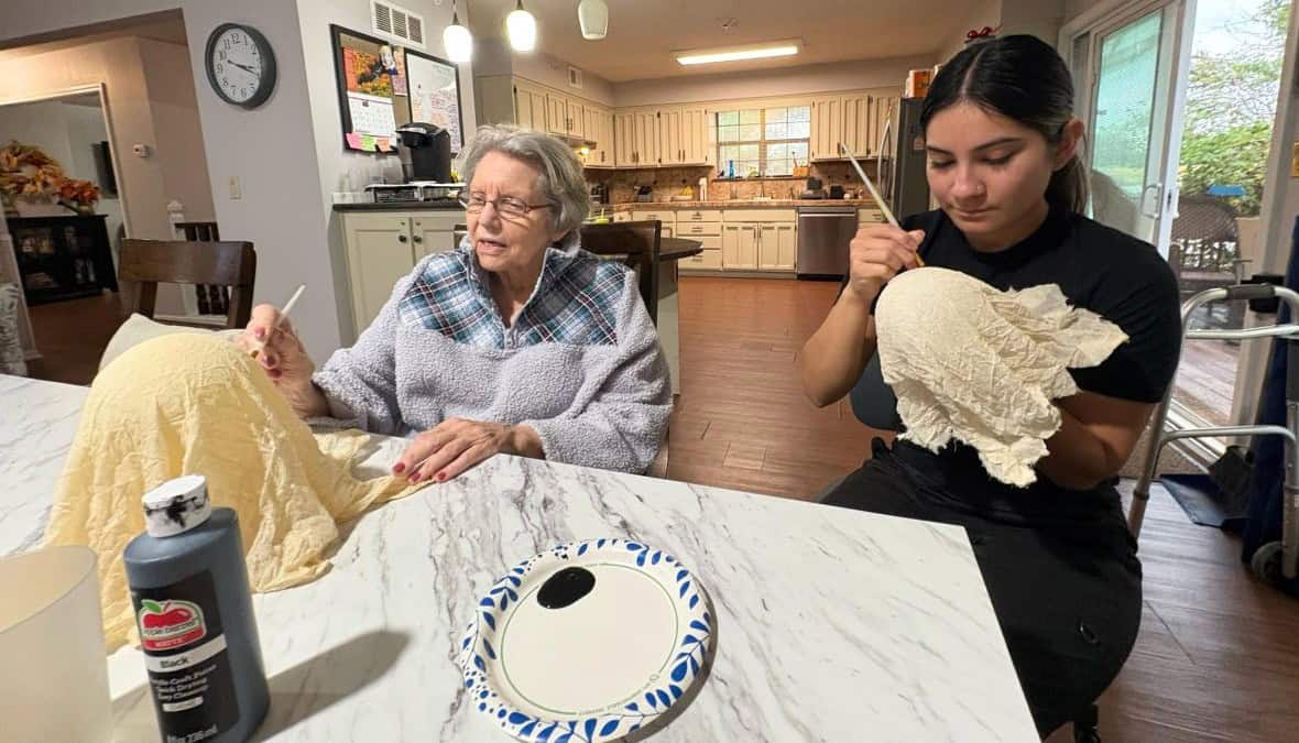 Nurse and elderly patient painting