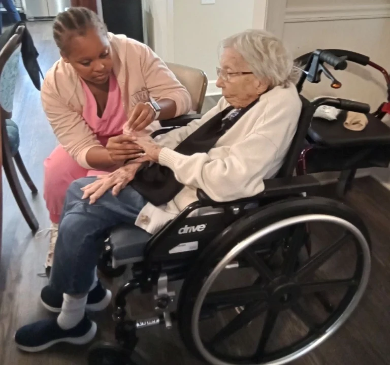 Nurse assisting a senior resident in a wheelchair at a compassionate senior care community