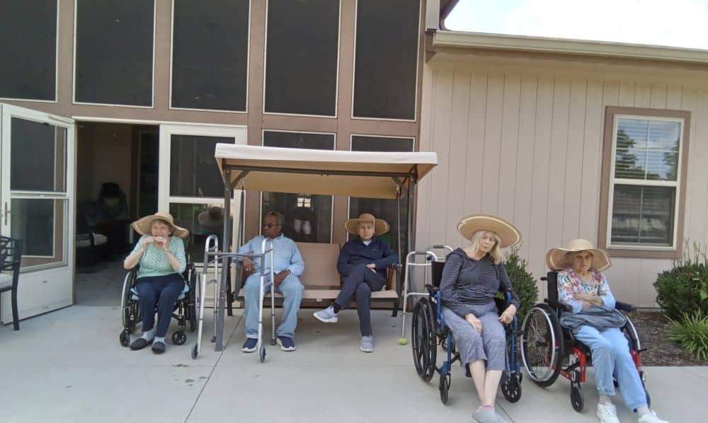 Senior-citizens-sitting-on-a-bench-and-wheel-chairs