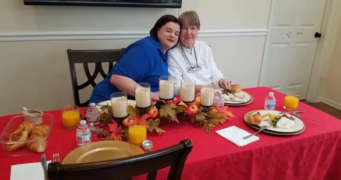 Two senior women enjoying dinner together in a comfortable senior care community